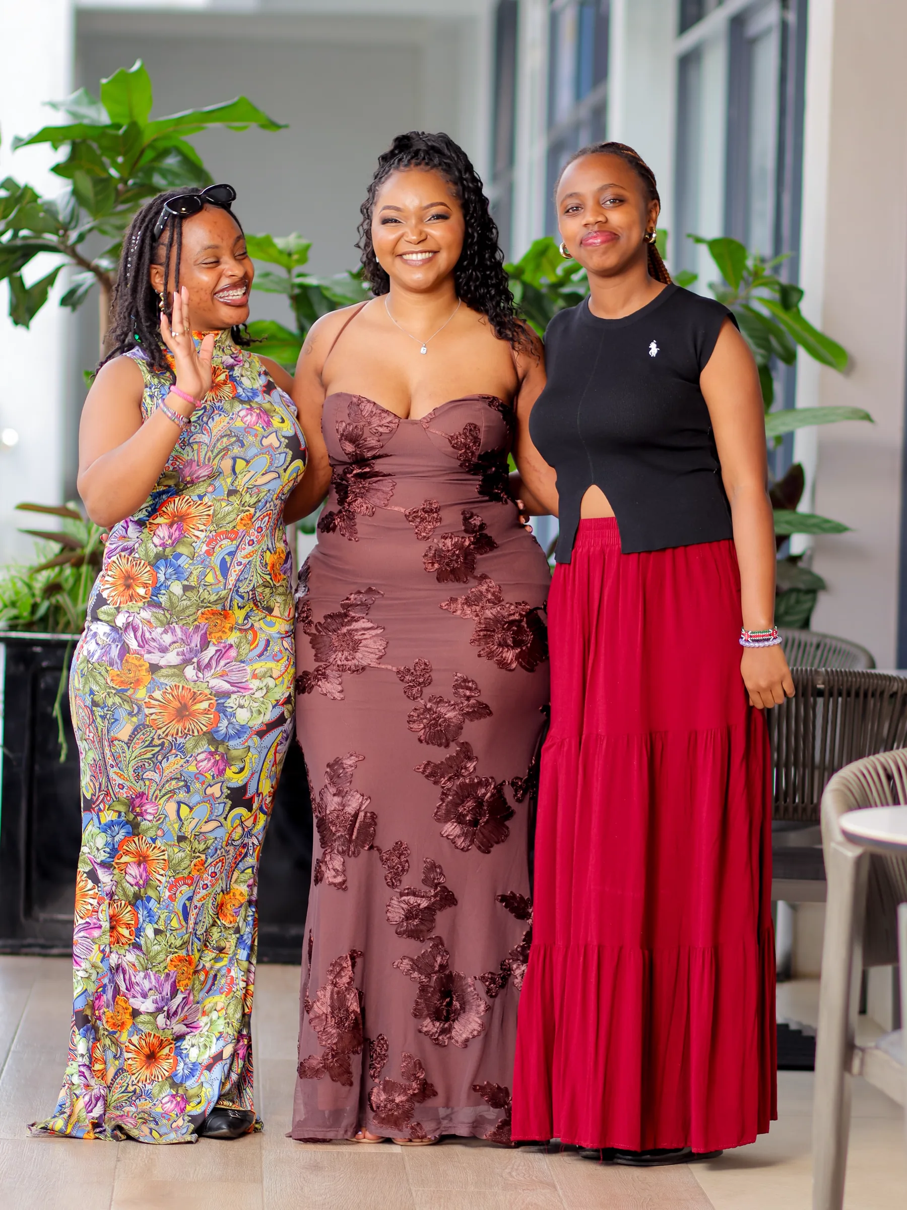 Moreen laughing with two friends at a celebration