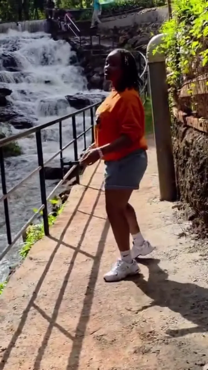 Moreen looking out toward a waterfall during an outing